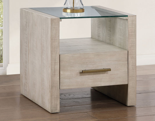 Beige nightstand with glass top and drawer on a wooden floor.